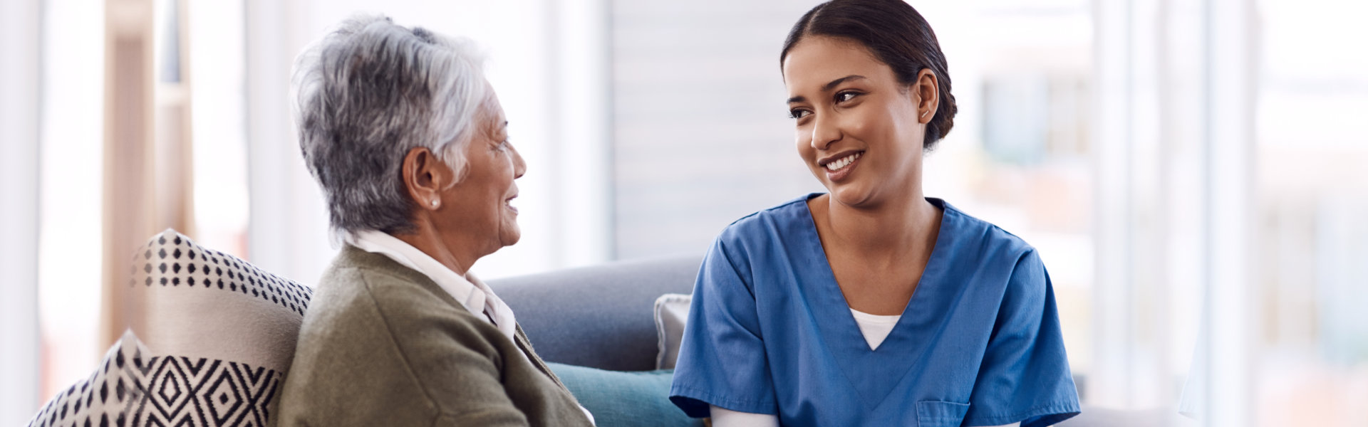 nurse and elderly woman smiling