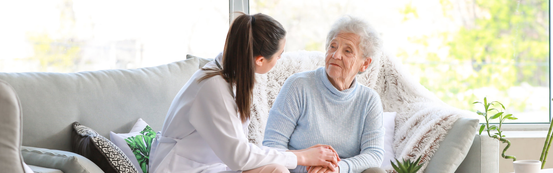 nurse and elderly woman sitting