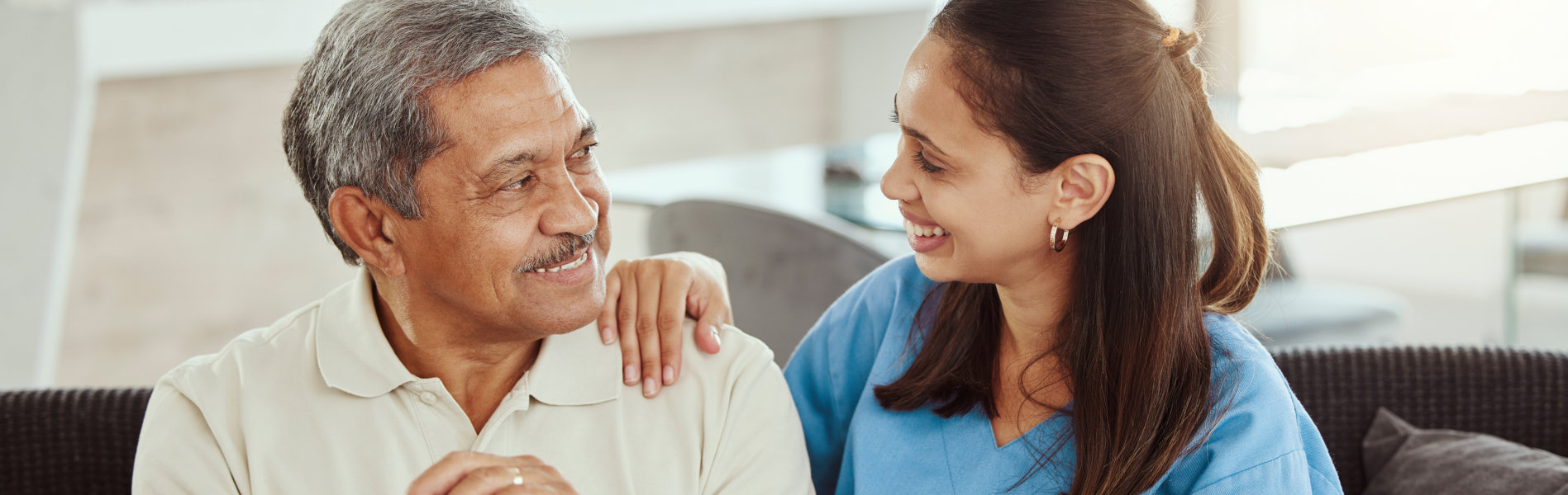 nurse and senior man looking at each other