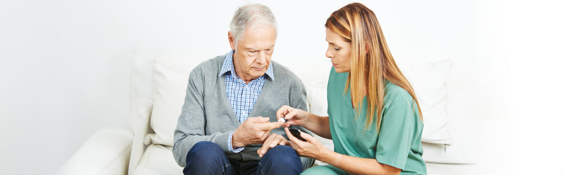 nurse and elderly man sitting